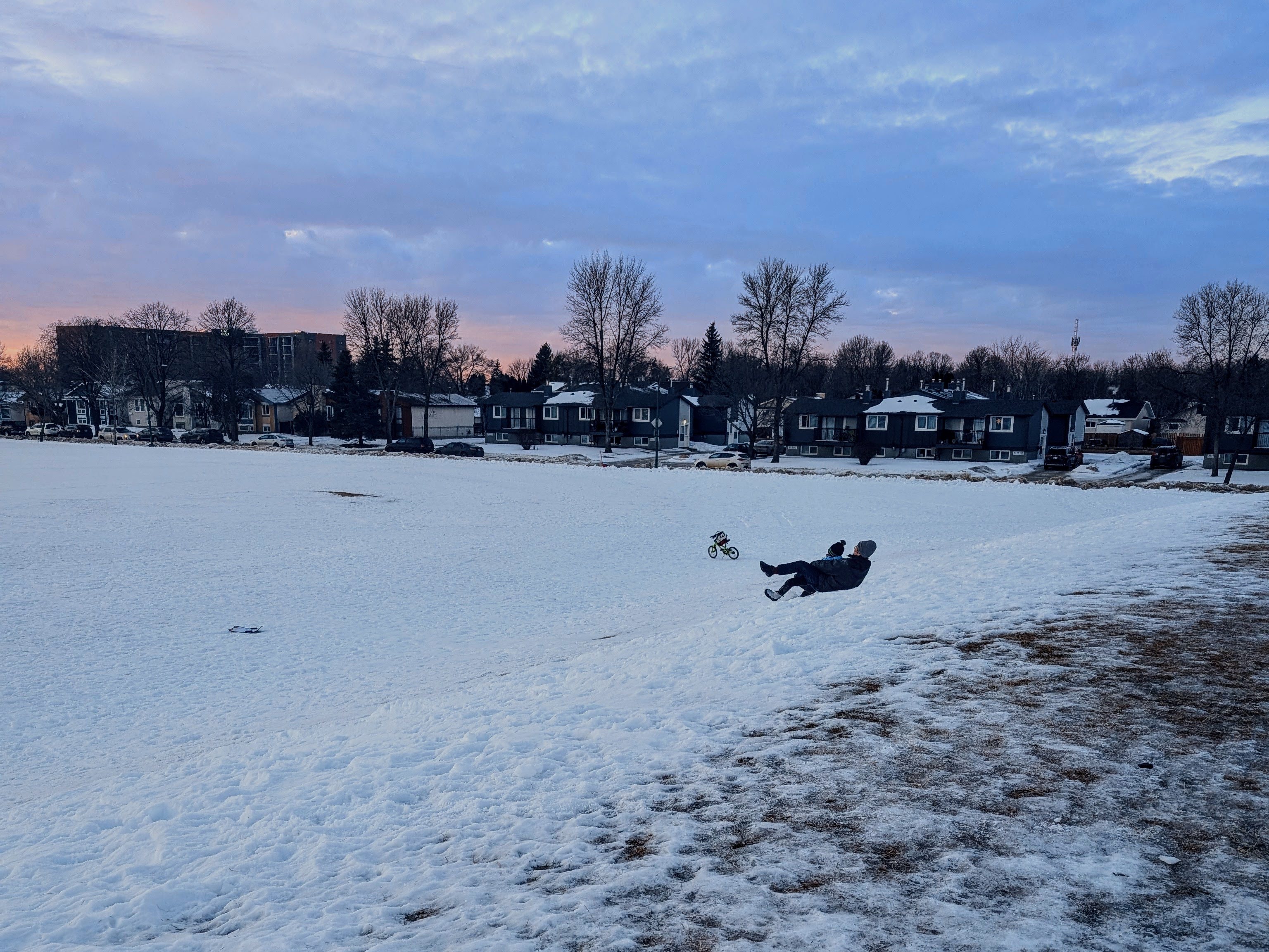 Man tobogganing with a child